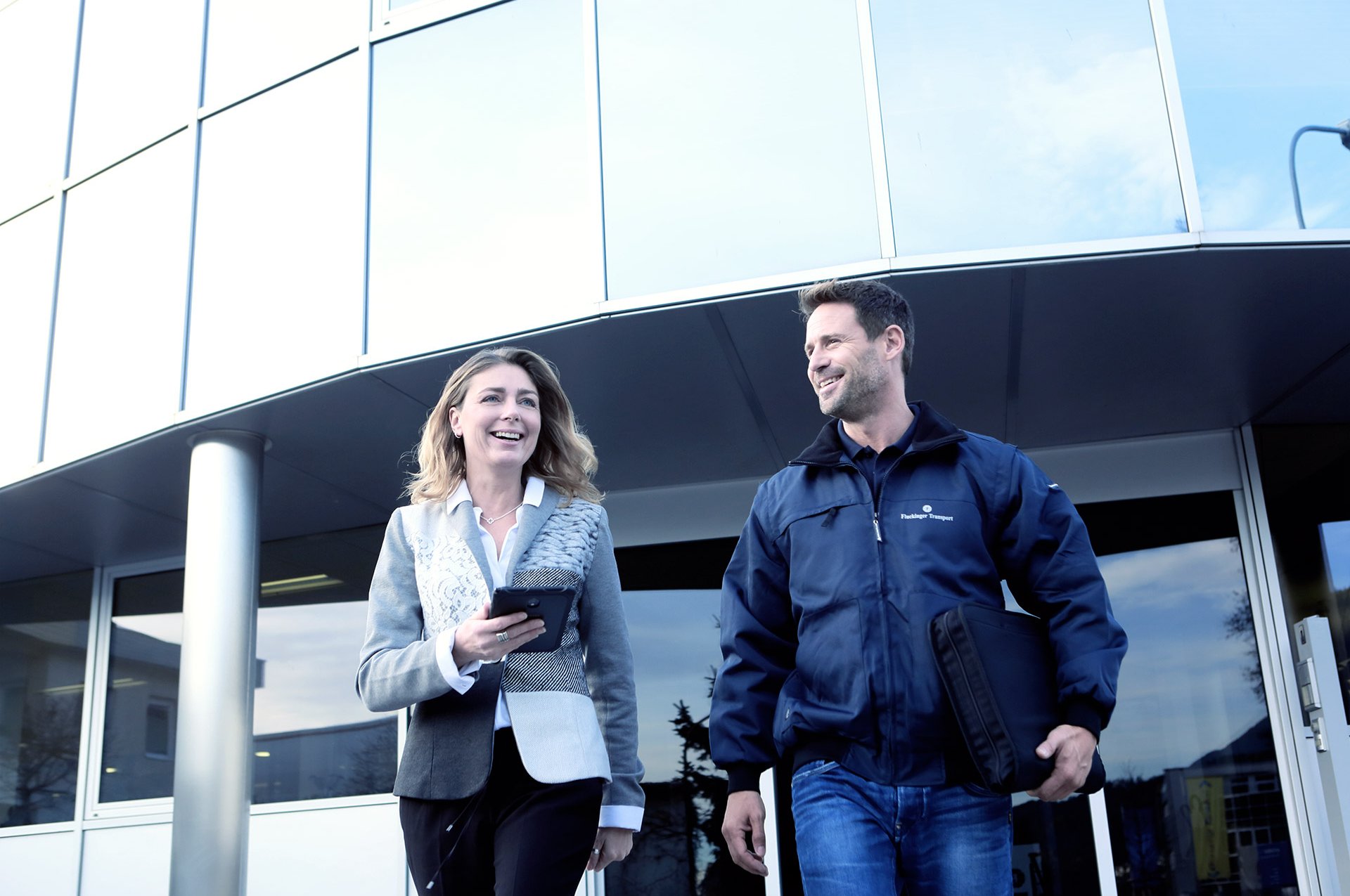 A Fluckinger employee and a customer in front of the Fluckinger building